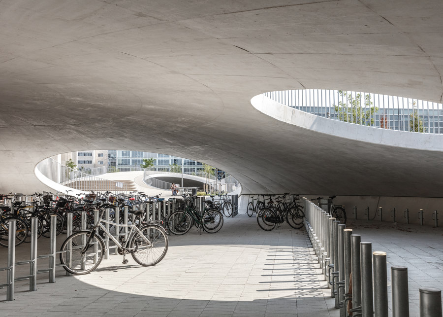 Bicycle parking under the hills de COBE | Construcciones Industriales