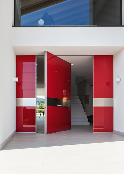 Synua | Porta blindata a bilico verticale con rivestimento in vetro lucido | Porte casa | Oikos Venezia – Architetture d’ingresso