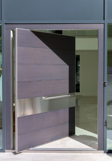 Synua | La porte blindée pour les grandes dimensions, avec fonctionnement
pivotant vertical et coplanaire au mur | Portes d'entrée | Oikos Venezia – Architetture d’ingresso